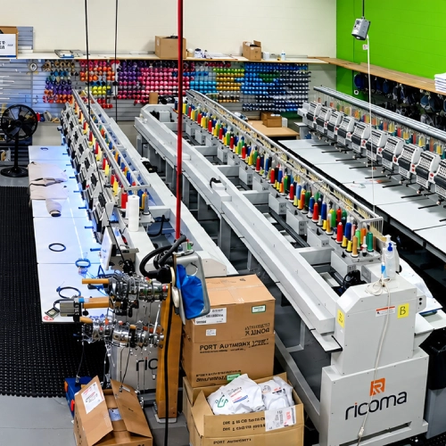 Row of multi-head embroidery machines in the shop